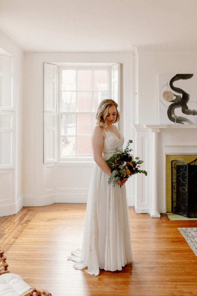 A bride in her suite at Blind Tiger Inn prepares for her Portland, Maine elopement.
