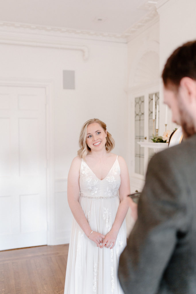A bride looks at her groom during an intimate ceremony at their Portland, Maine elopement.